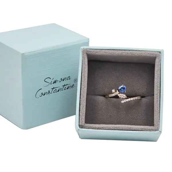 NATURA RING LEAFY BRANCH WITH ONE BLUE PEAR-SHAPED AND TINY WHITE STONES